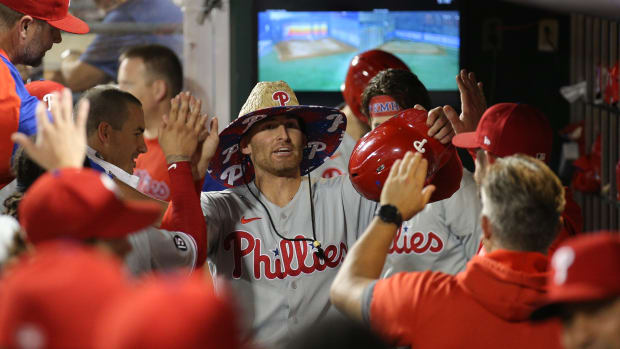 Sep 17, 2021; New York City, New York, USA; Philadelphia Phillies first baseman Brad Miller (13) wears a sombrero as he celebrates his solo home run against the New York Mets with teammates in the dugout during the fifth inning at Citi Field.