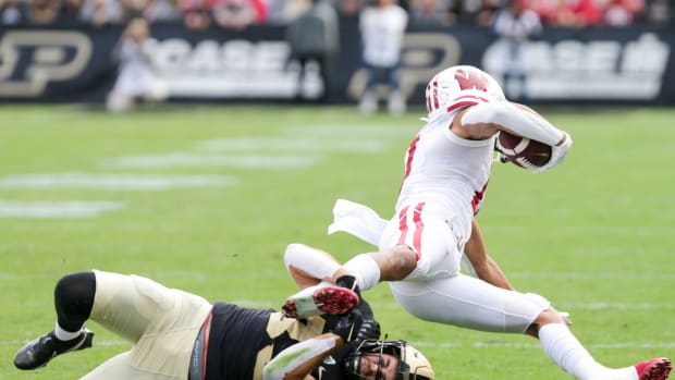 Wisconsin wide receiver Chimere Dike tackled by a Purdue defender