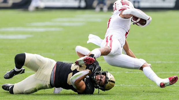 Wisconsin wide receiver Chimere Dike tackled by a Purdue defender