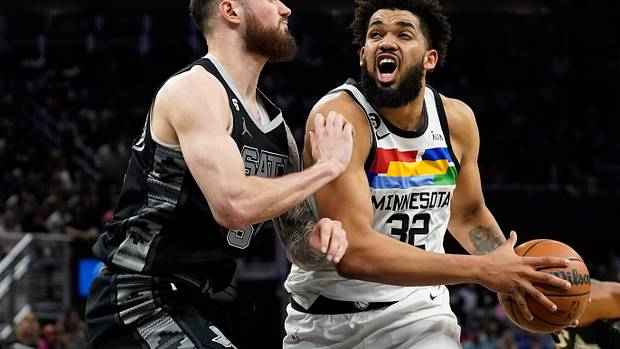 San Antonio Spurs center Sandro Mamukelashvili defending Minnesota Timberwolves forward Karl-Anthony Towns.