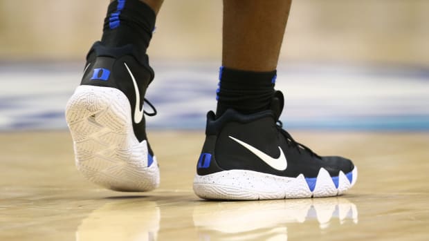 View of a Duke Blue Devils basketball player's black and white sneakers.