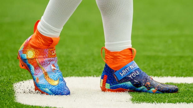 Denver Broncos quarterback Russell Wilson's blue and orange Nike cleats.
