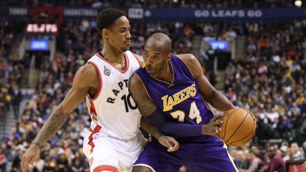 Los Angeles Lakers guard Kobe Bryant (24) goes up against Toronto Raptors guard DeMar DeRozan (10)