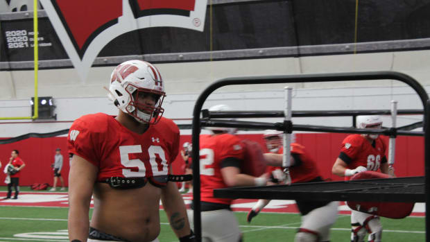Wisconsin right tackle Logan Brown walking back after a rep during spring practice.