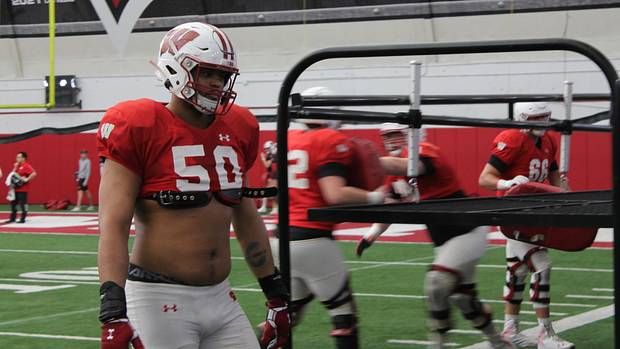 Wisconsin right tackle Logan Brown walking back after a rep during spring practice.