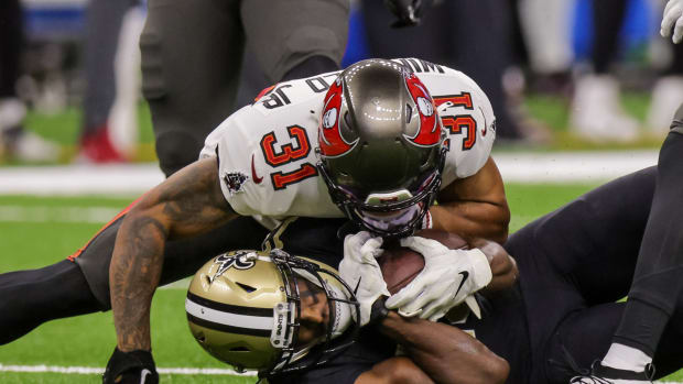 Sep 18, 2022; New Orleans, Louisiana, USA; Tampa Bay Buccaneers safety Antoine Winfield Jr. (31) tackles New Orleans Saints wide receiver Michael Thomas (13) during the first half at Caesars Superdome. Mandatory Credit: Stephen Lew-USA TODAY Sports