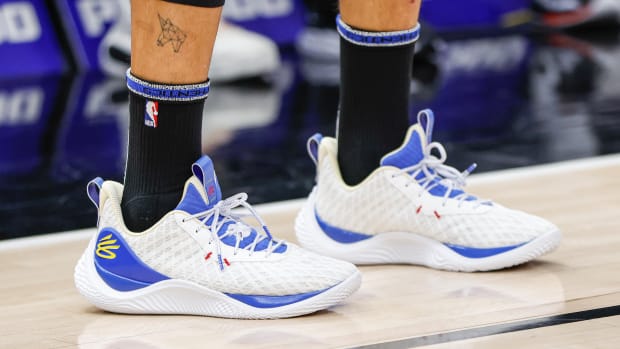 View of white and blue Curry shoes.