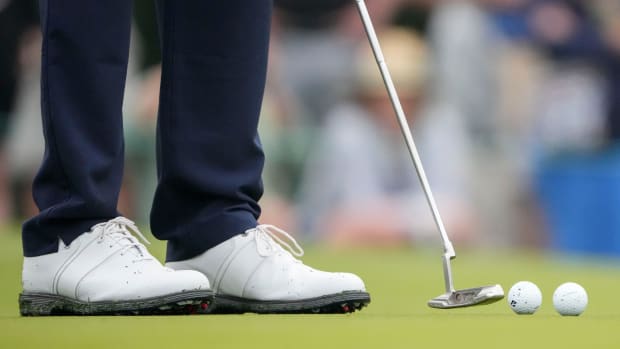 View of Tiger Woods' white golf shoes.