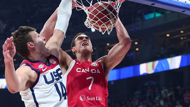 Canada's Dwight Powell dunks over Team USA's Walker Kessler.