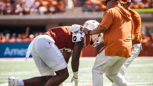 Texas tight end Ja'Tavion Sanders (0) is helped off the field by Texas staff in the first quarter of the Longhorns' game against the Kansas Jayhawks, Saturday, Sept. 30 at Darrell K Royal-Texas Memorial Stadium