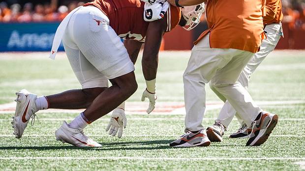 Texas tight end Ja'Tavion Sanders (0) is helped off the field by Texas staff in the first quarter of the Longhorns' game against the Kansas Jayhawks, Saturday, Sept. 30 at Darrell K Royal-Texas Memorial Stadium