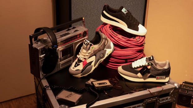 PUMA sneakers propped on a stereo system.