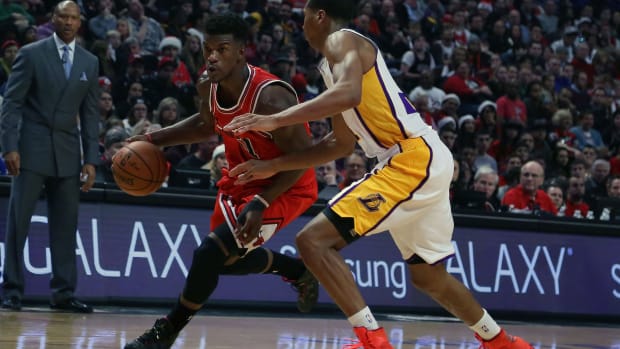 Chicago Bulls guard Jimmy Butler dribbles past Los Angeles Lakers forward Wesley Johnson.