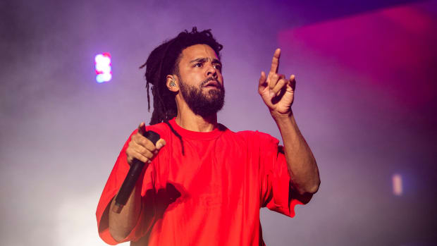 J. Cole performing on stage.