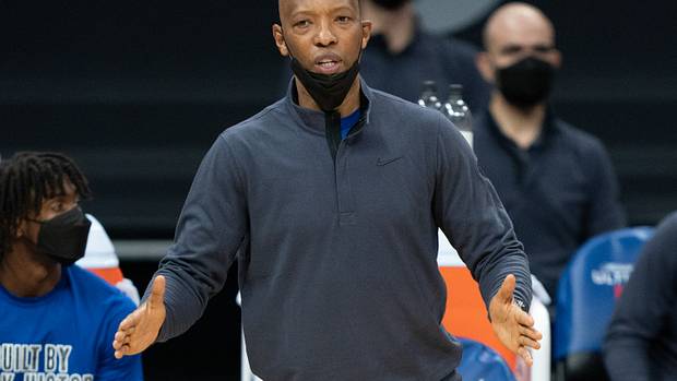 Sam Cassell stands on the sidelines.