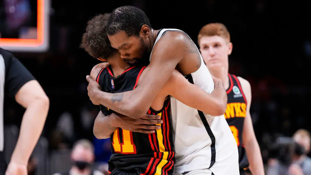 Atlanta Hawks guard Trae Young (11) and Brooklyn Nets forward Kevin Durant (7) hug after the Nets defeated the Hawks at State Farm Arena.