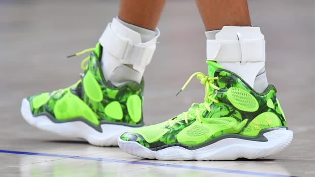 Golden State Warriors guard Stephen Curry's green and white Under Armour shoes.