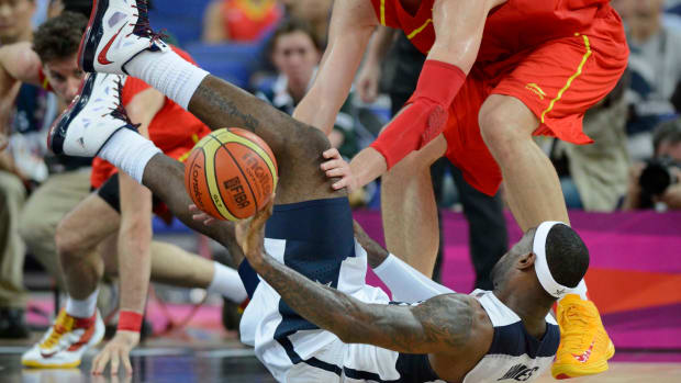 Team USA forward LeBron James falls on a loose ball in the 2012 Olympic Games.