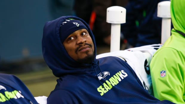 Marshawn Lynch reclines back on the bench.