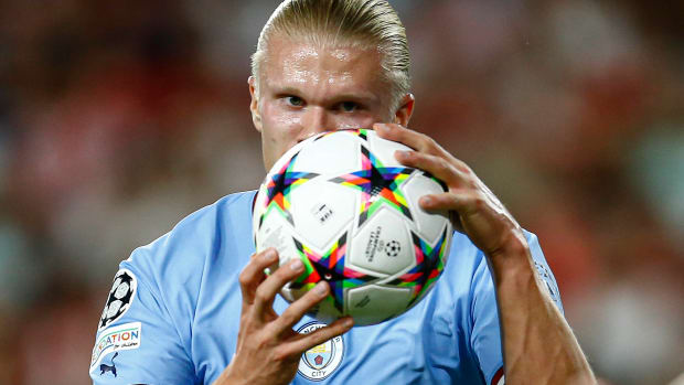 Erling Haaland pictured holding the ball after scoring the first Champions League goal of his Manchester City career - against Sevilla in September 2022