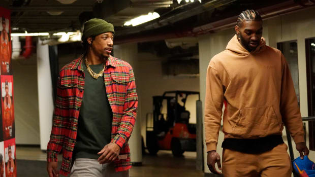 Mar 22, 2023; Chicago, Illinois, USA; Chicago Bulls forward DeMar DeRozan (left) and forward Patrick Williams (right) enter the building before the game against the Philadelphia 76ers