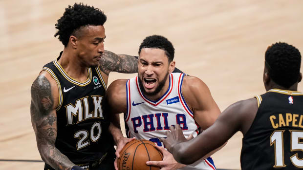 Jun 18, 2021; Atlanta, Georgia, USA; Philadelphia 76ers guard Ben Simmons (25) drives to the basket against Atlanta Hawks forward John Collins (20) during the first half in game six in the second round of the 2021 NBA Playoffs. at State Farm Arena.