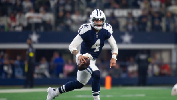 Dallas Cowboys quarterback Dak Prescott runs with the football.