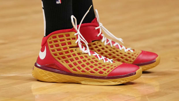 View of the red and gold Nike Kobe 3 'All-Star' sneakers worn by P.J. Tucker.