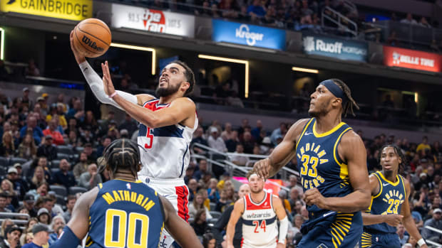 Washington Wizards guard Tyus Jones (5) shoots the ball while Indiana Pacers guard Bennedict Mathurin (00) defends in the second quarter at Gainbridge Fieldhouse.