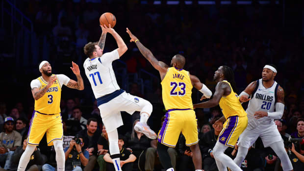 Dallas Mavericks star Luka Doncic shoots a Dirk Nowitzki-esque one-legged fadeaway over Los Angeles Lakers' LeBron James.