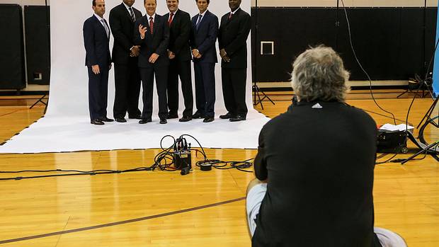 Atlanta Hawks head coach Mike Budenholzer (third from left) and his staff pose for team photographer Scott Cunningham during media day at Philips Arena.