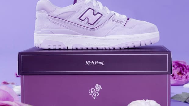 Side view of purple and white New Balance 550 sneakers.