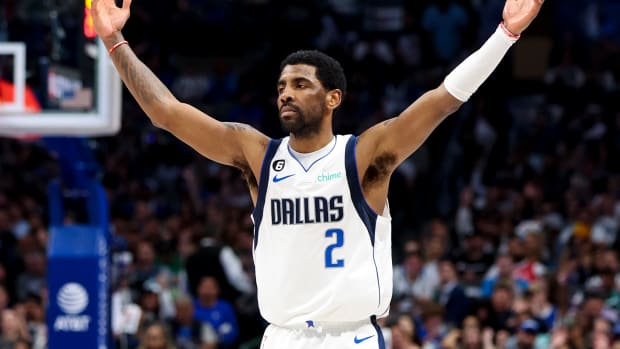 Dallas Mavericks guard Kyrie Irving celebrates a made shot.