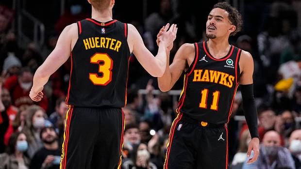 Hawks guards Kevin Huerter and Trae Young celebrate a play.