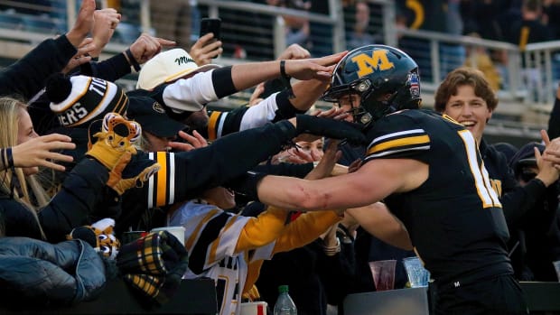 Missouri Tigers quarterback Brady Cook (12) celebrates with his family after a touchdown run in the second half. Missouri went on to win 36-7 to improve to 8-2 on its season.