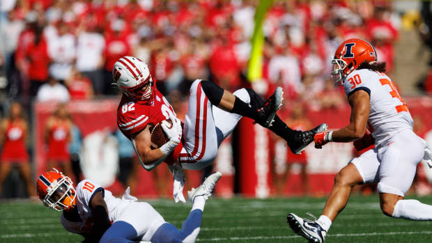 Wisconsin tight end Jack Eschenbach is tackled in the open field against Illinois.
