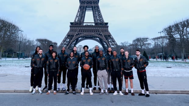 The Cleveland Cavaliers pose for a team photo in front of the Eiffel Tower in Paris, France.