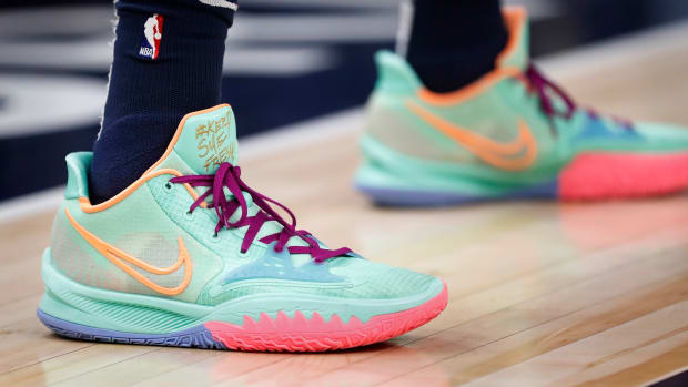 View of teal and pink Nike Kyrie Low 4 sneakers.