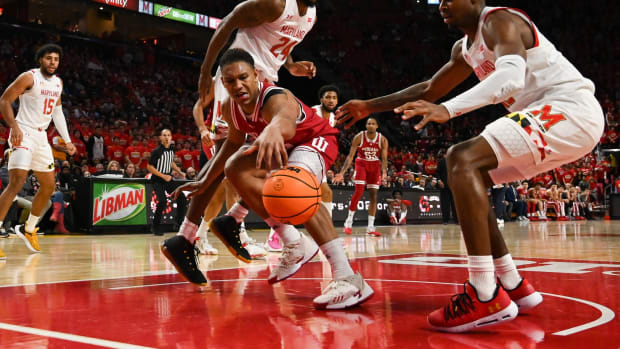 Indiana Hoosiers forward Malik Reneau (5) reaches for a loose ball as Maryland Terrapins Hakim Hart (13) and Donta Scott (24) defend during the first half at Xfinity Center.