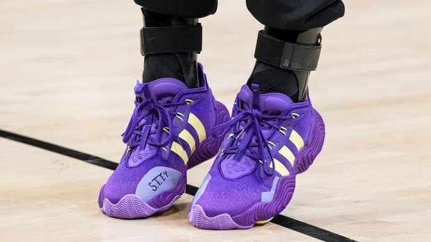 Atlanta Hawks guard Trae Young's purple and gold adidas sneakers.