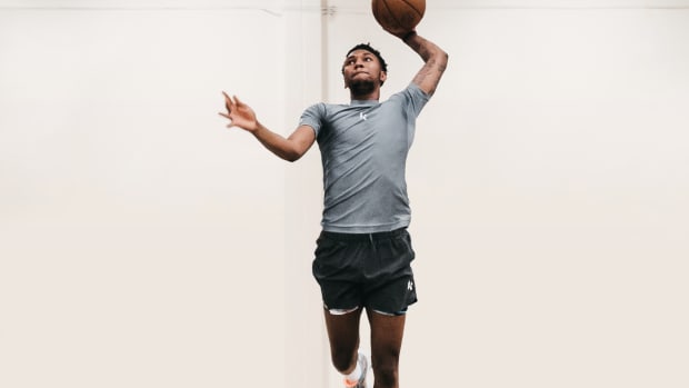 Justin Edwards dunks a basketball in a New Balance photo shoot.