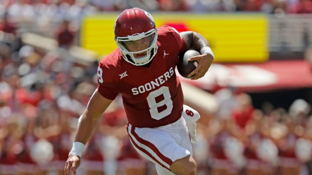 Scenes at a college football game as Oklahoma Sooners quarterback Dillon Gabriel makes a play.