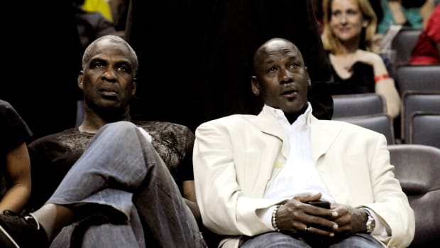 Michael Jordan sits with Charles Oakley at an NBA game in 2010