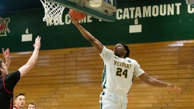 Vermont s Ben Shungu (24) leaps for a layup during the America East semi final basketball game between the Hartford Hawks and the Vermont Catamounts at Patrick Gym on Saturday afternoon March 6, 2021 in Burlington, Vermont. America East Semi Finals Hartford Vs Vermont 03 06 21