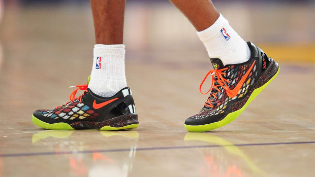View of black and orange Nike Kobe shoes.
