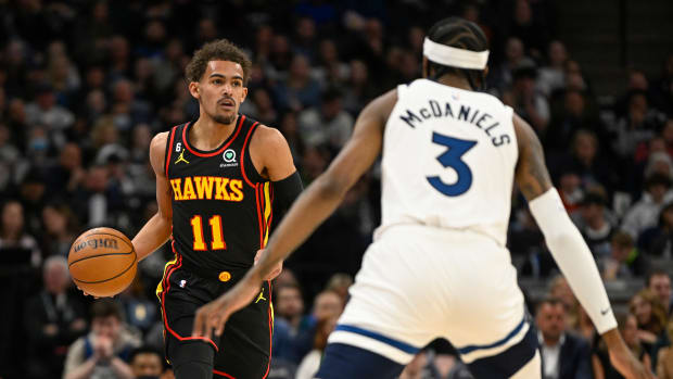 Atlanta Hawks guard Trae Young dribbles against Minnesota Timberwolves forward Jaden McDaniels.