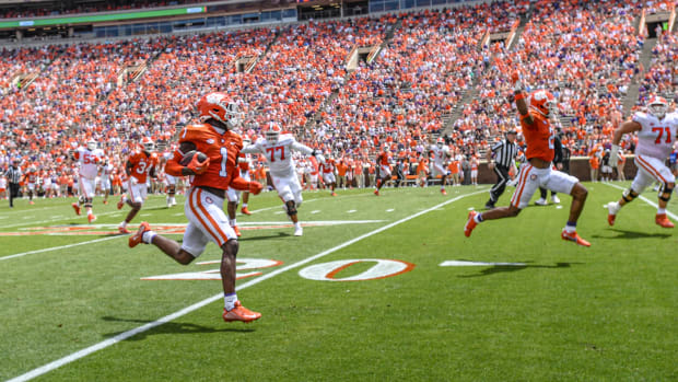 Clemson Tigers safety Andrew Mukuba runs with the ball.