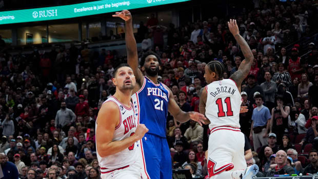 Philadelphia 76ers center Joel Embiid vs. Chicago Bulls' DeMar DeRozan and Nikola Vucevic at United Center