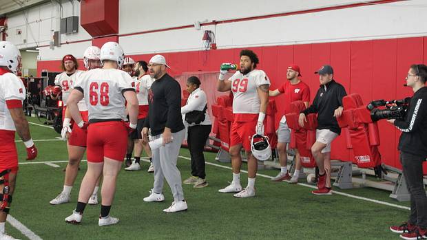 Defensive line coach Ross Kolodziej speaking with his group.