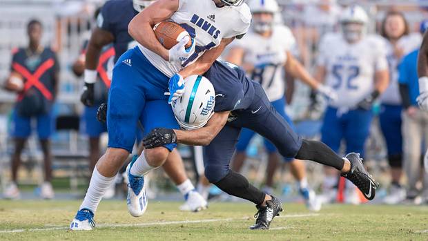 DII tight end Kyle Morlock running the football to avoid a tackle.